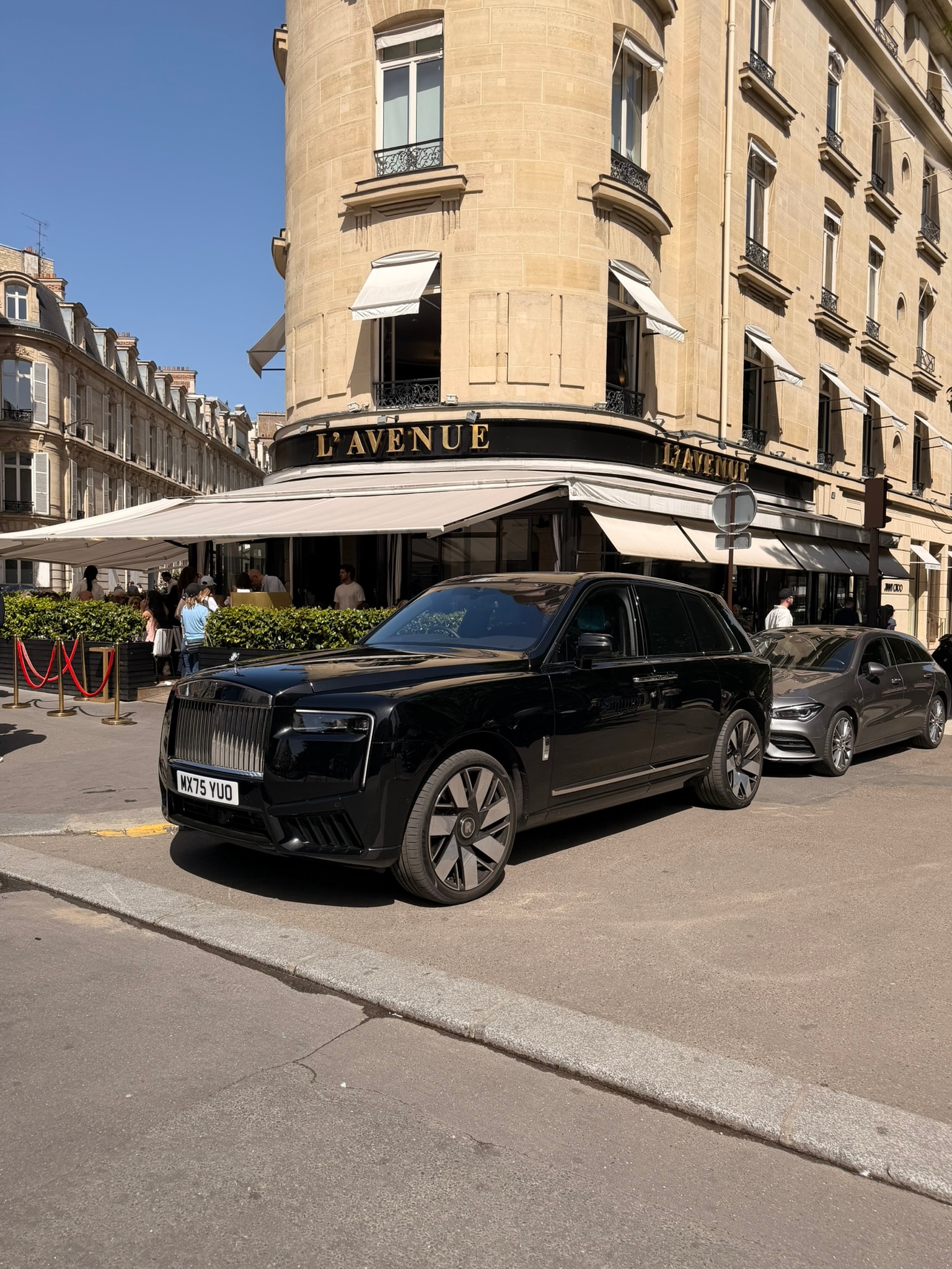 Black Range Rover Autobiography parked outside a luxury London storefront